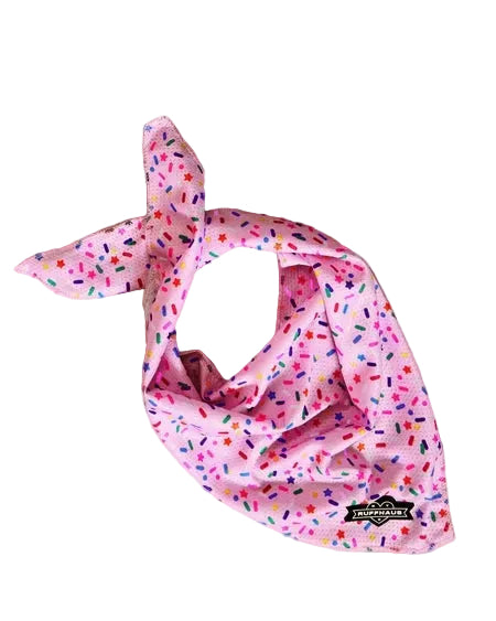 Luna Doodle Boutique Sprinkle Me Pink cooling bandana for dogs, featuring a pink and white sprinkle pattern, laid flat.