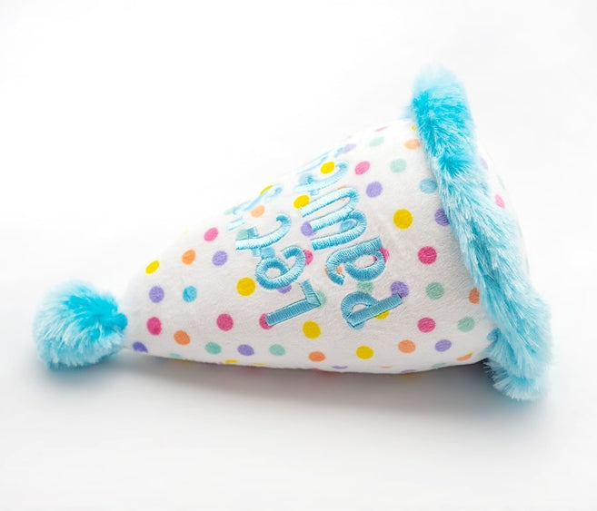 Blue plush birthday hat dog toy by Luna Doodle Boutique, soft fabric with festive design, perfect for playful pups.