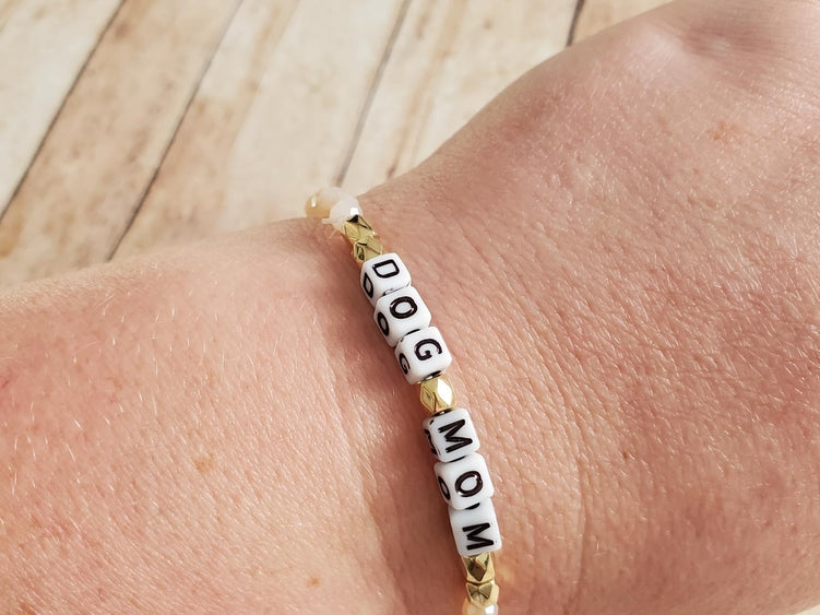 Beaded stretch bracelet for dog moms with paw and bone charms, crafted by Luna Doodle Boutique, stylish and adjustable accessory.